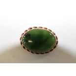 A 9ct gold brooch with green jade stone