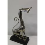 An unusual metal dog sculpture on plinth. 54cm tall