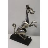 An unusual metal dog sculpture on plinth. 50cm tall