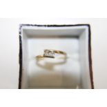 A 9ct gold two stone cross over ring size N