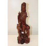 A large carved redwood Oriental sculpture. 48cm tall