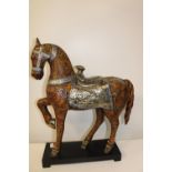 A large unusual resin horse figure on stand. 64cm x 50cm