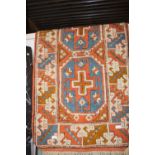 A vintage woollen rug. 1.4 meters x 76cm