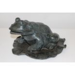 A large bronze frog on lily pad 20cm tall X 40cm long