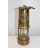 A vintage brass miners lamp. Height 25cm