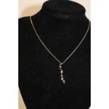 A 9ct white gold pendant & chain with white stones