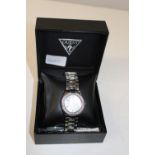 A boxed Guess watch