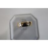 A large 9ct gold band ring. Size V 6.2 grams
