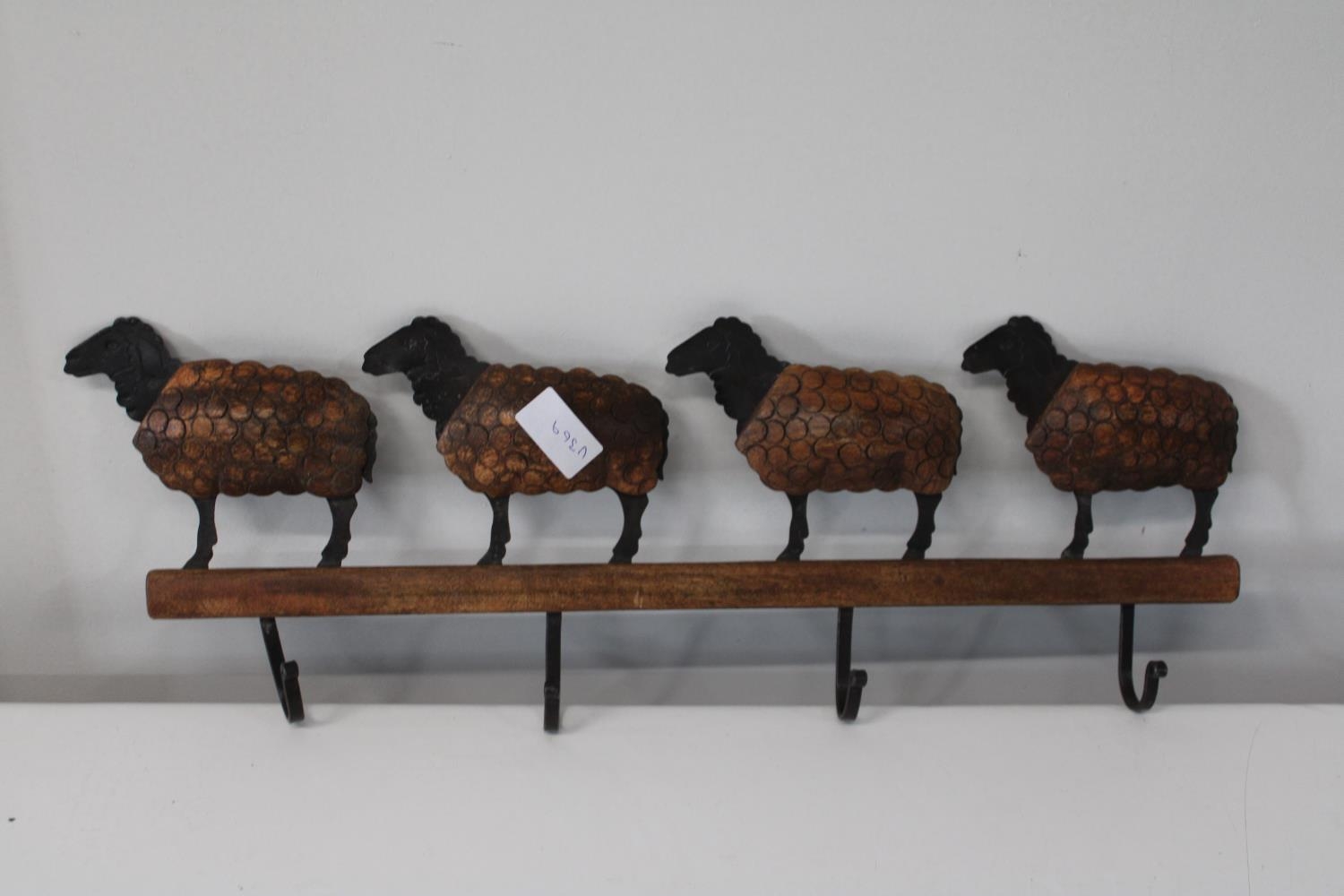 A metal a wooden coat rack in the form of sheep