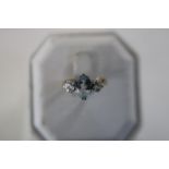 A 18ct gold & platinum ring with a central aquamarine stone flanked by two large diamonds size J 1/2