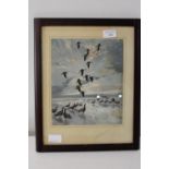 A framed print of geese in flight 39x31cm