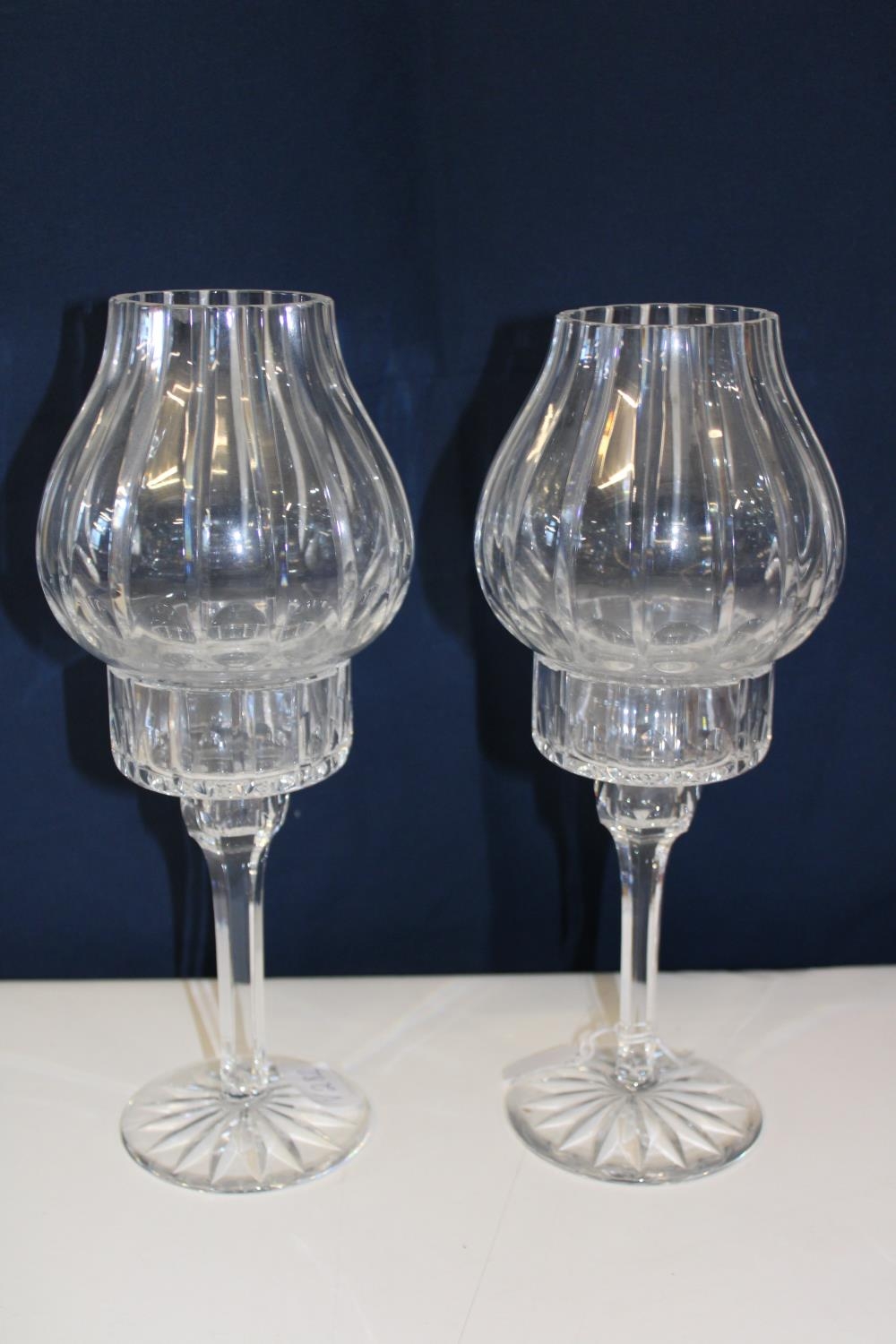 A pair of cut glass candle holders with shades. Height 31cm
