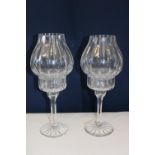 A pair of cut glass candle holders with shades. Height 31cm