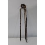 Three vintage wooden walking sticks