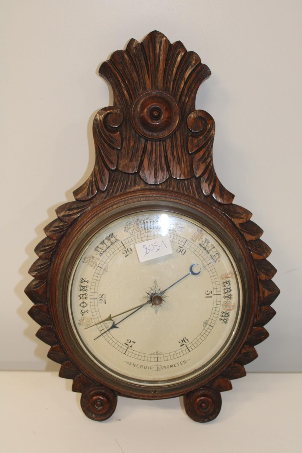 A oak framed aneroid barometer 48cm in length
