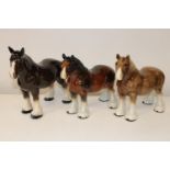 Three large ceramic shire horses