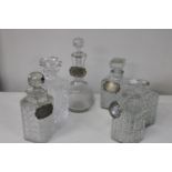 A job lot of assorted decanters & labels