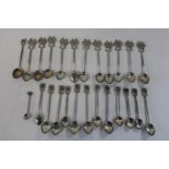 A large selection of white metal spoons