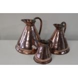 Three vintage graduated copper jugs largest is 26cm tall