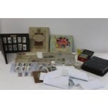 A box of vintage cigarette card albums and loose cards