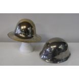 Two chromed military helmets one dated 1941