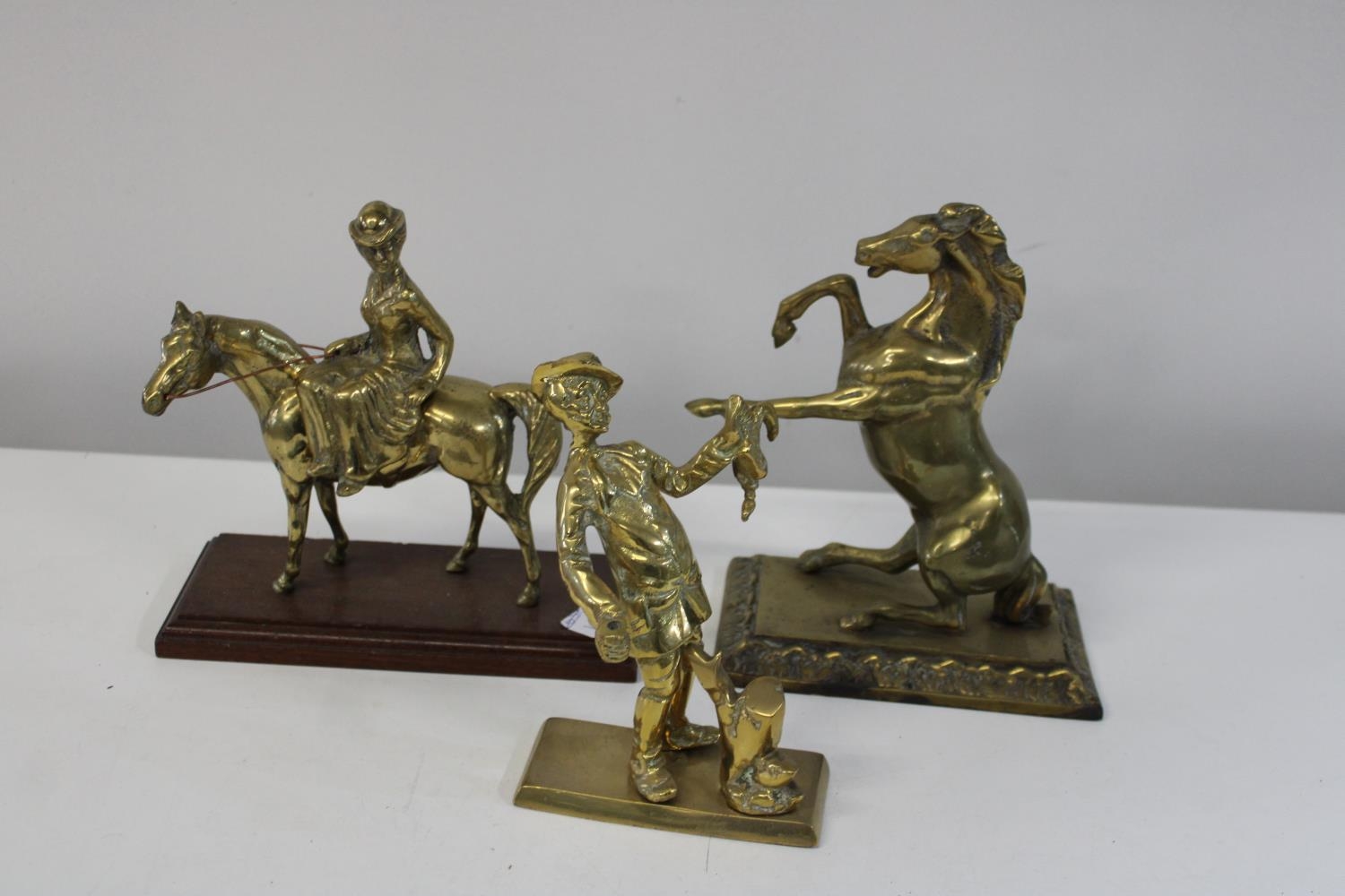 Three assorted brass figures