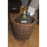 A glass carbuoy in a wicker basket collection only