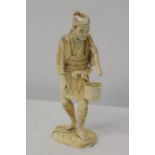 A sectional antique ivory figurine signed to the base 25cm tall. Sold as seen