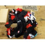 A box of assorted sports cycling wear clothing
