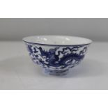 A Chinese blue & white bowl decorated with dragon & pheonix. Six character mark to the base