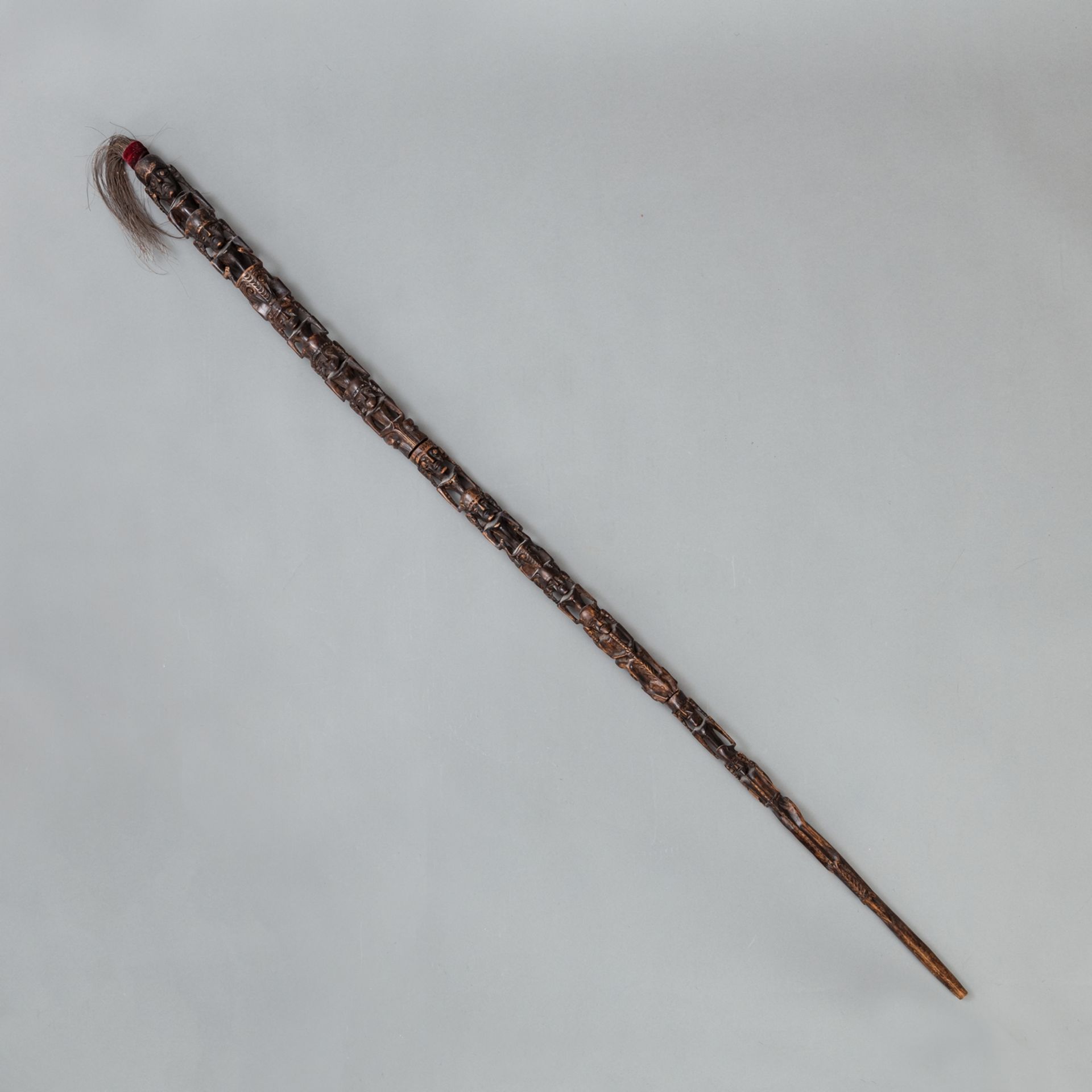 A  LONG  CARVED STAFF WITH RICH FIGURAL CARVING