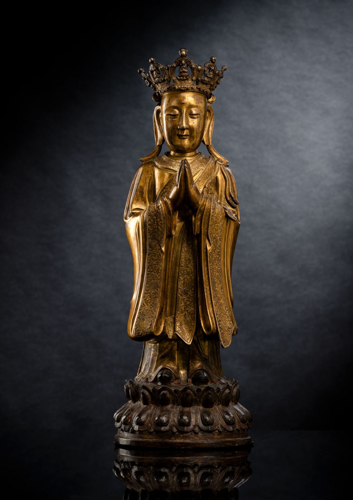 A FINE AND RARE GILT-BRONZE FIGURE OF ANANDA WITH CROWN