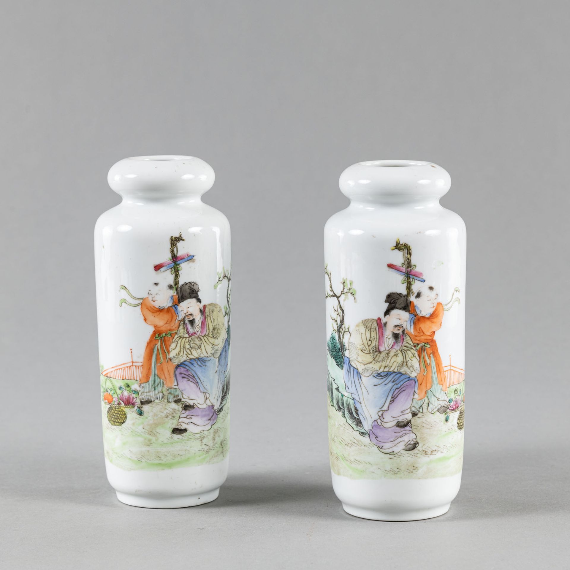 A PAIR OF CYLINDRICAL 'FAMILLE ROSE' SCHOLAR WITH BOY VASES