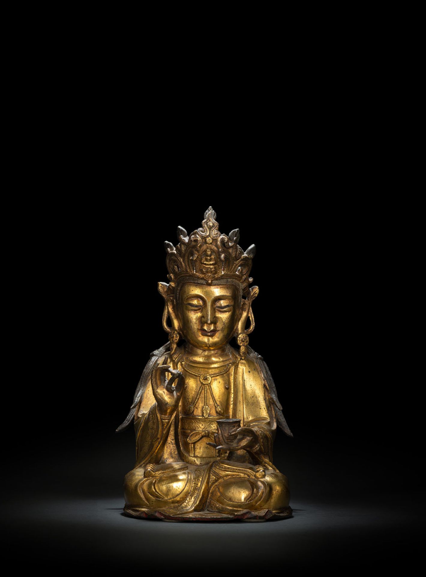 A GILT-BRONZE FIGURE OF SEATED GUANYIN