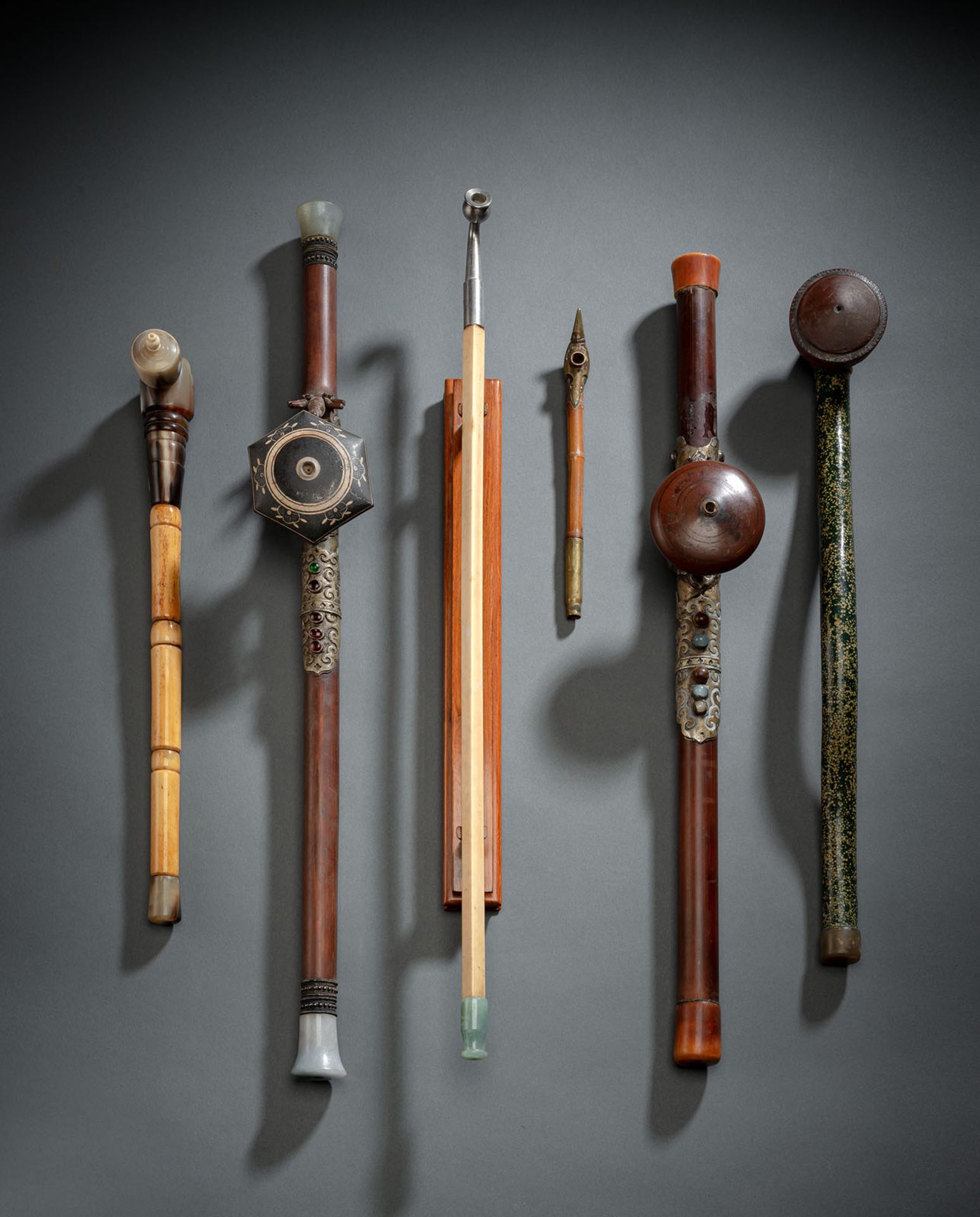 A GROUP OF SIX OPIUM PIPES, PARTLY WORKED IN IVORY, BAMBOO AND HORN