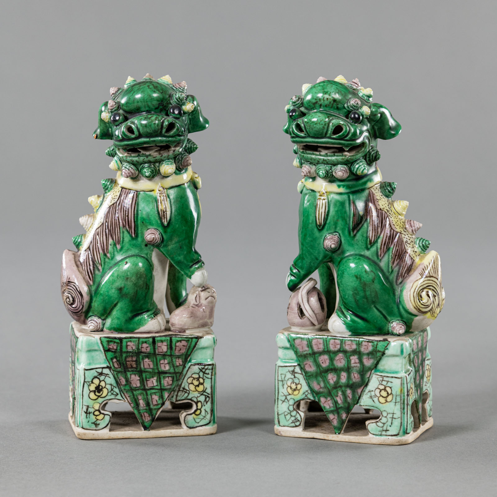 A PAIR OF POLYCHROME BISCUIT PORCELAIN FO LIONS