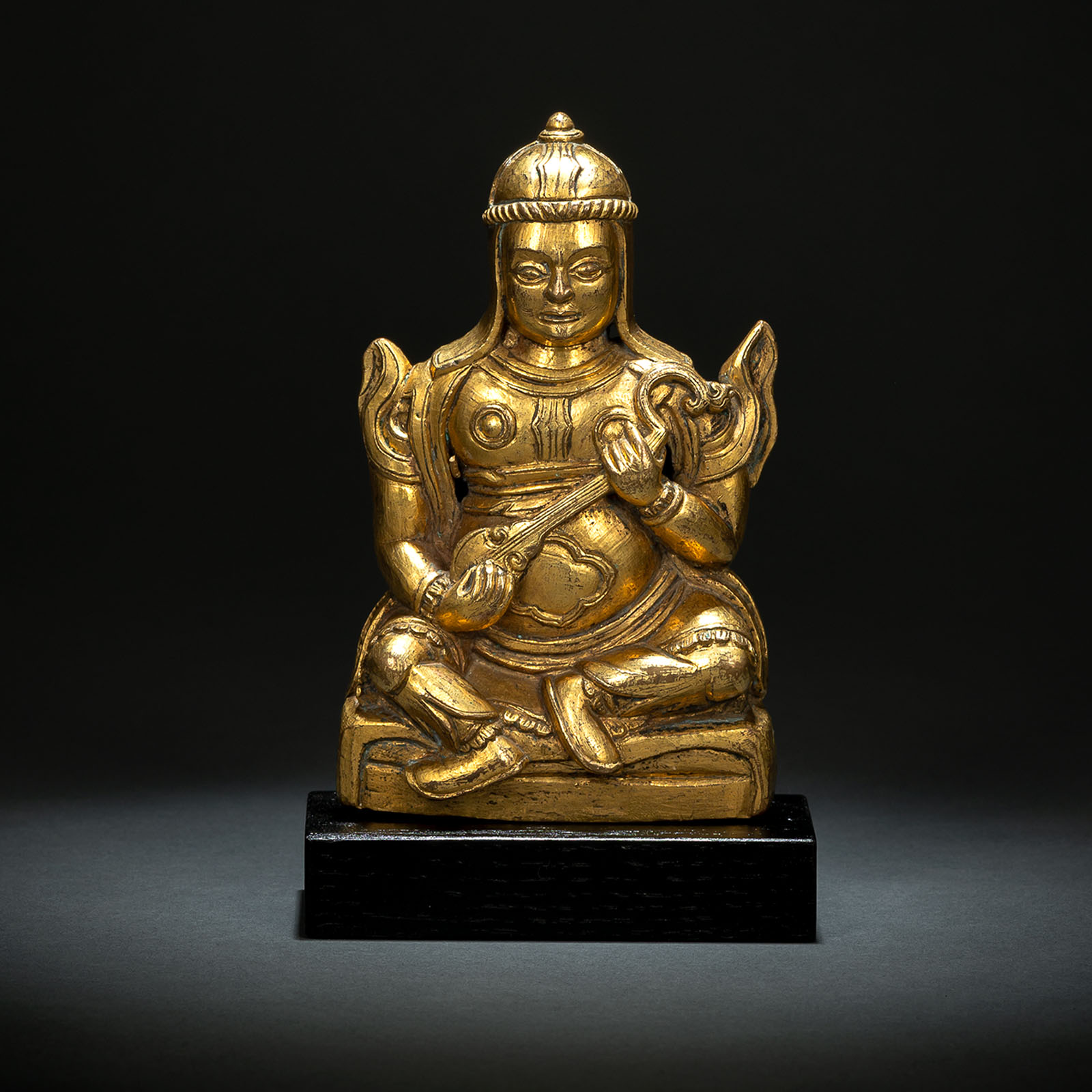 A GILT-BRONZE FIGURE OF DHRTARASTRA