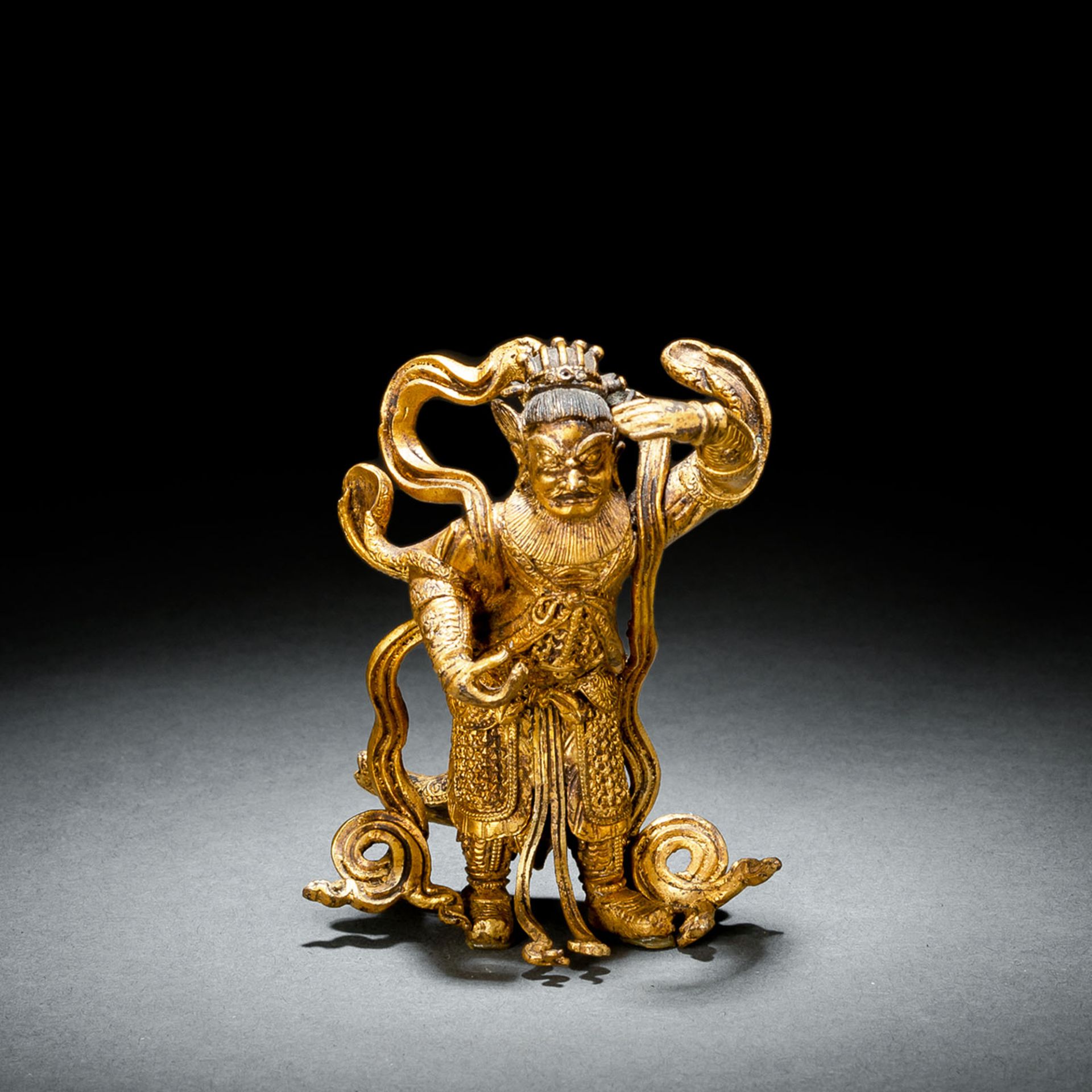 A FINE GILT-BRONZE FIGURE OF A STANDING GUARDIAN