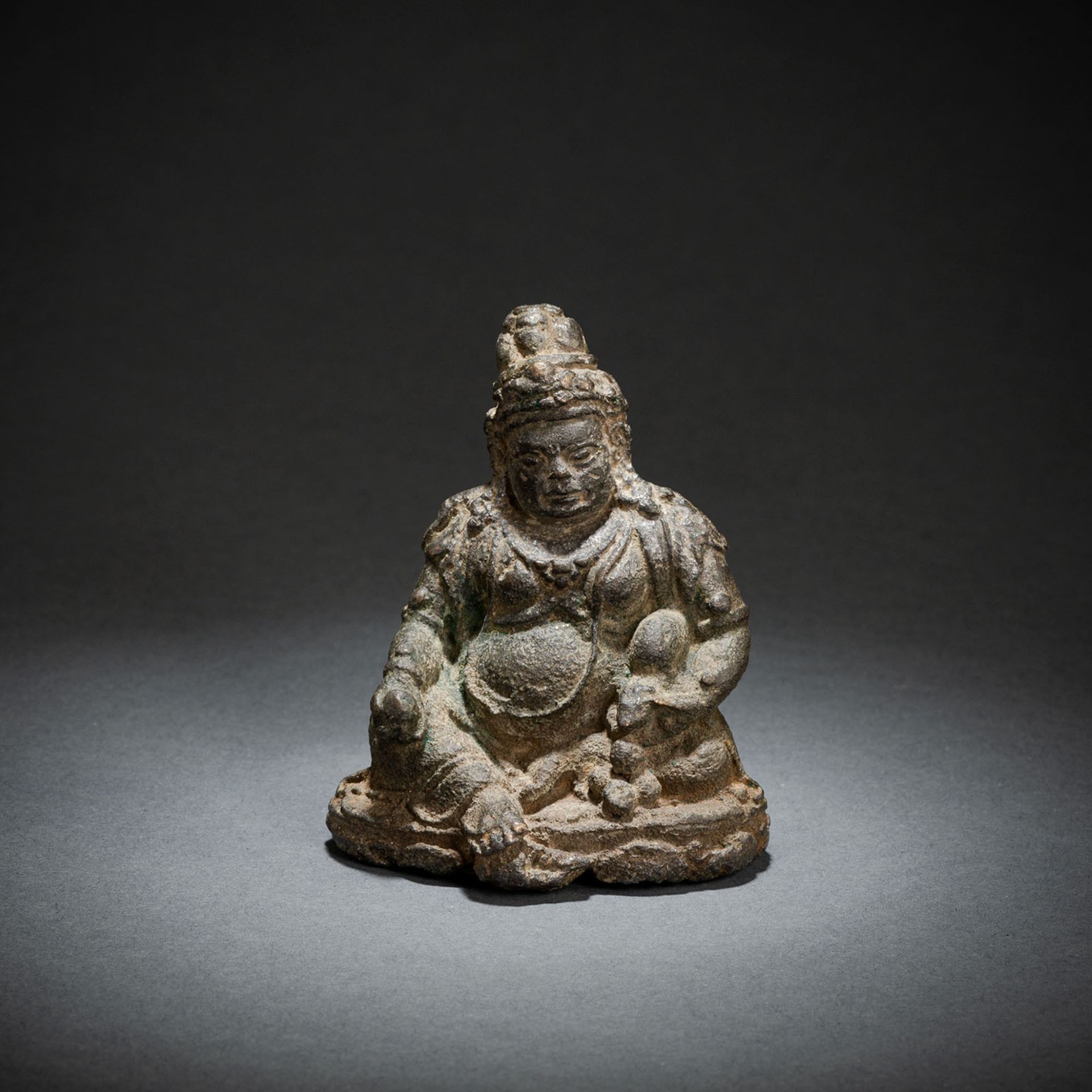 A RARE IRON FIGURE OF JAMBHALA