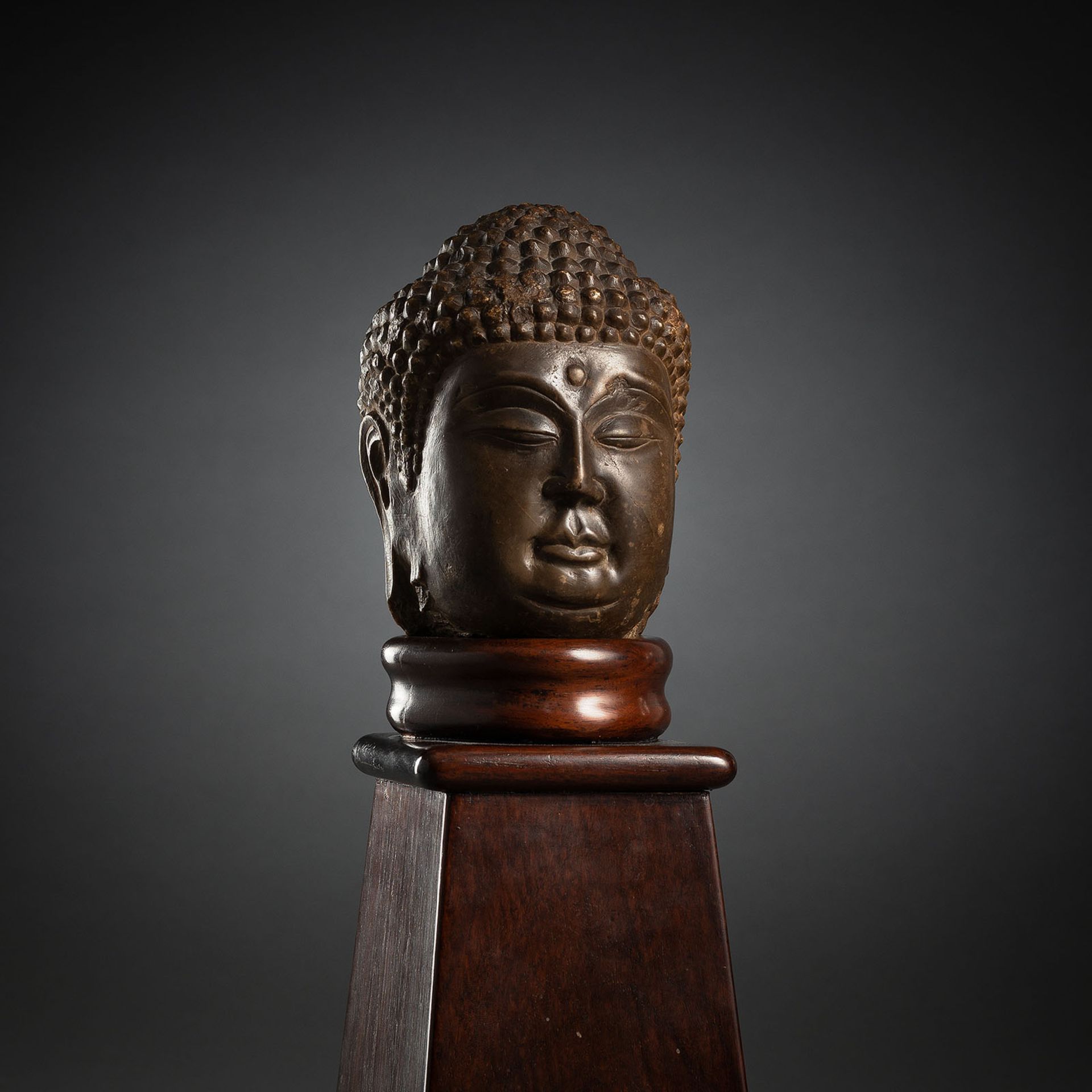 A LIMESTONE HEAD OF BUDDHA SHAKYAMUNI