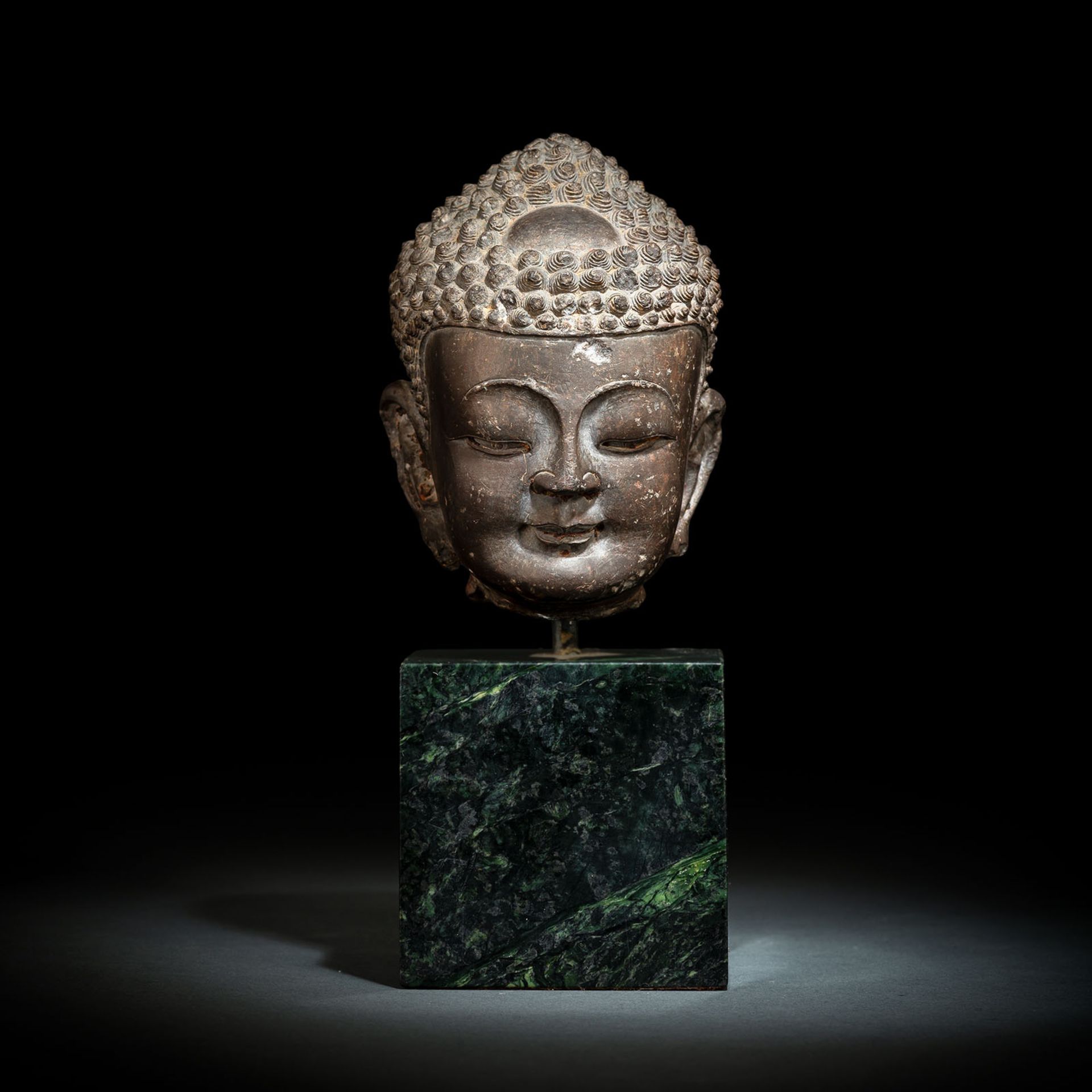 A FINE CARVED GREY-BROWN CARVED STONE HEAD OF BUDDHA SHAKYAMUNI