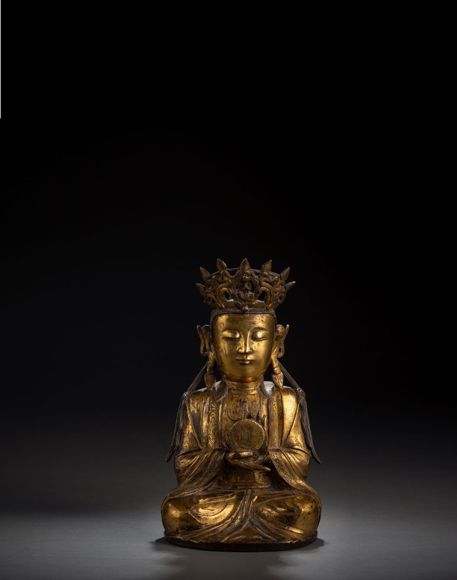 A RARE GILT-BRONZE FIGURE OF SURYABRAHA WITH SUN DISK