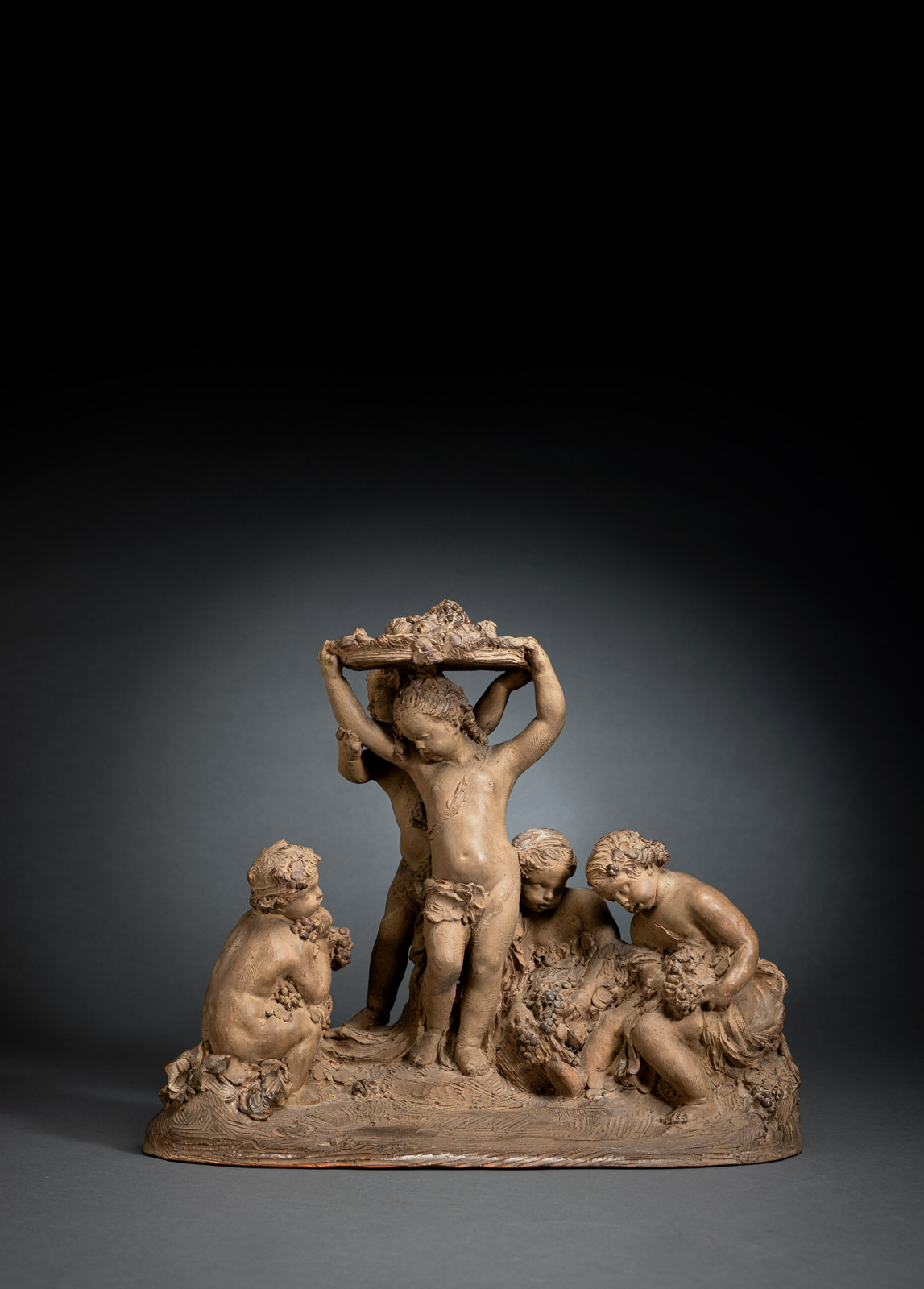 A TERRACOTTA GROUP WITH BACCHANTES