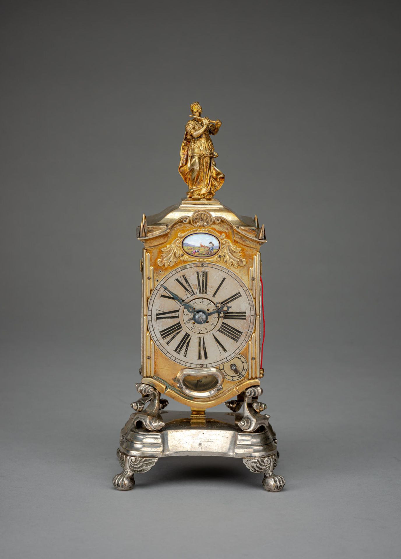 AN IMPORTANT GERMAN GILTBRASS AND SILVERED BAROQUE TABLE CLOCK