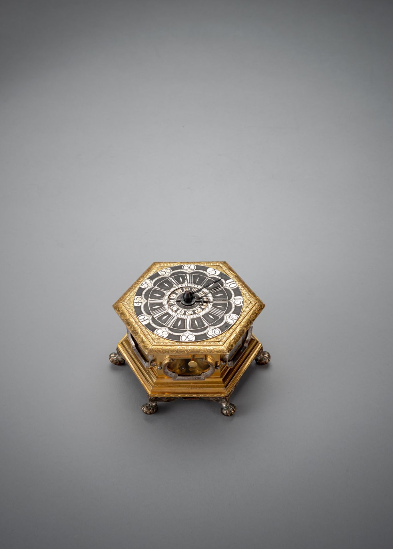 A SMALL GERMAN HEXAGONAL QUARTER STRIKING AND ALARM HORIZONTAL TABLE CLOCK