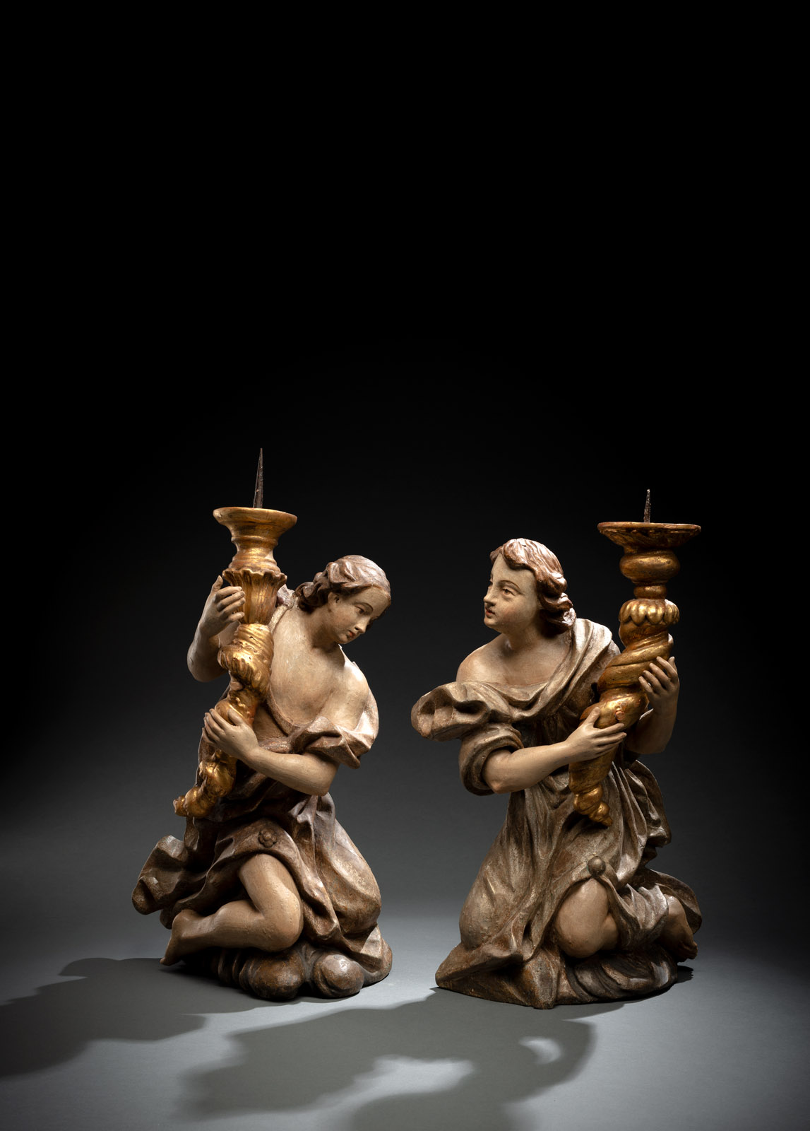 A PAIR OF BAROQUE ANGELS WITH CANDLESTICKS