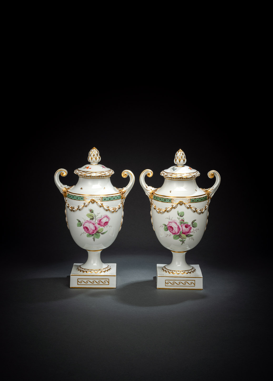 A PAIR OF FLORAL PATTERN VASES AND COVERS