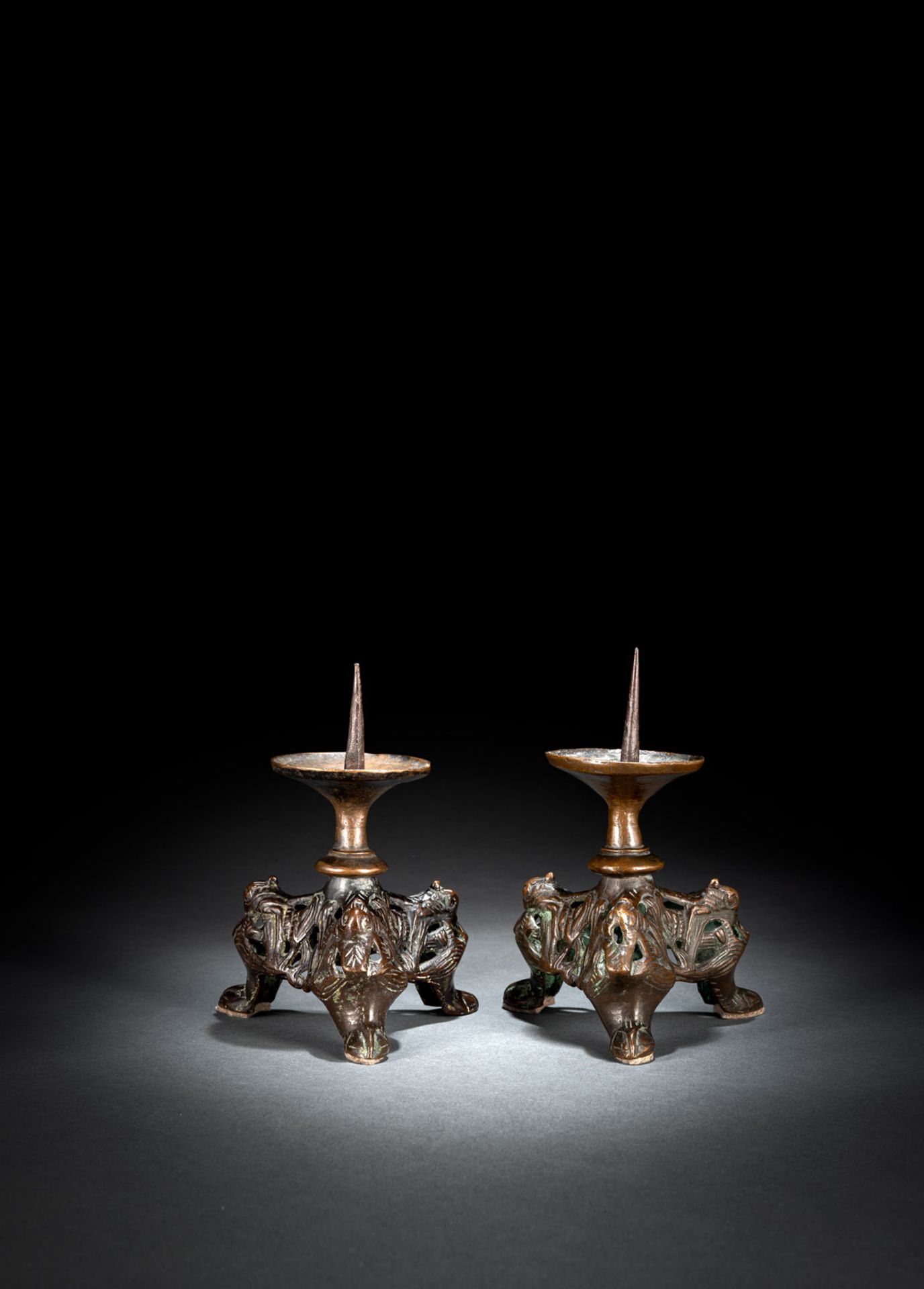 A PAIR OF MEDIEVAL OPENWORK BRONZE TRIPOT CANDLESTICKS