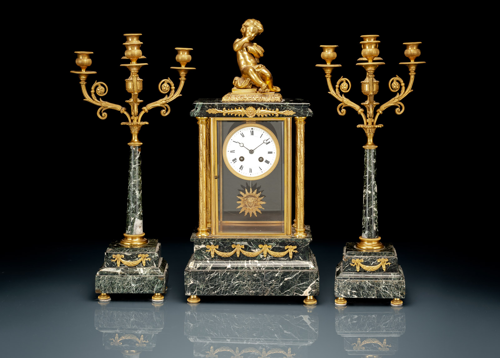 A FRENCH GREEN MARBLE AND BRONZE THREE-PIECE CLOCK GARNITURE