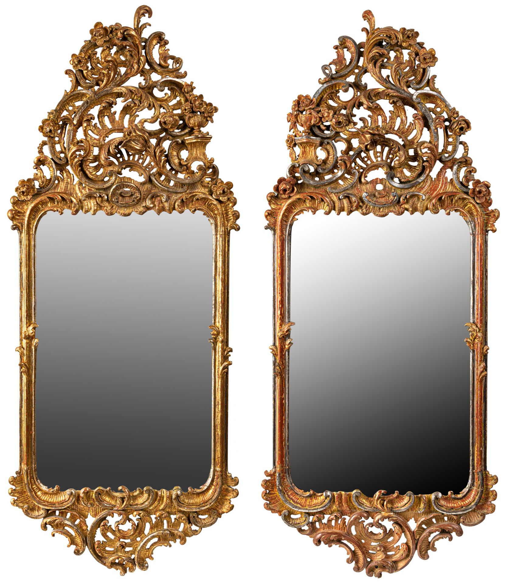 A PAIR OF ELABORATE ROCAILLE FOLIAGE AND FLOWER TOOLED CARVED WOOD WALL MIRRORS